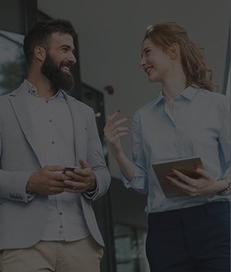 Man and woman in business attired standing and talking