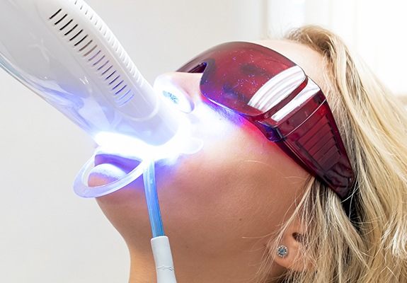 Woman receiving teeth whitening treatment