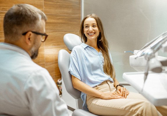 Patient smiling while talking to cosmetic dentist
