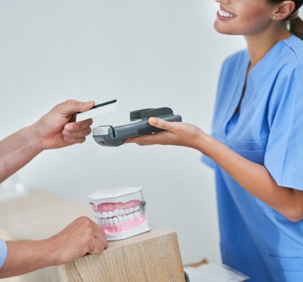Patient paying for the cost of cosmetic dentistry 