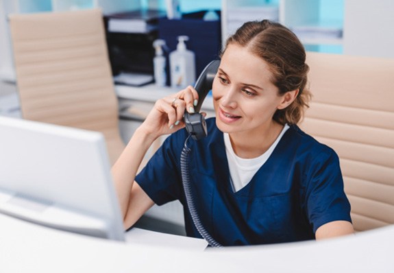 Dental team member talking on telephone