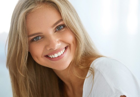 patient smiling after getting dental crown 