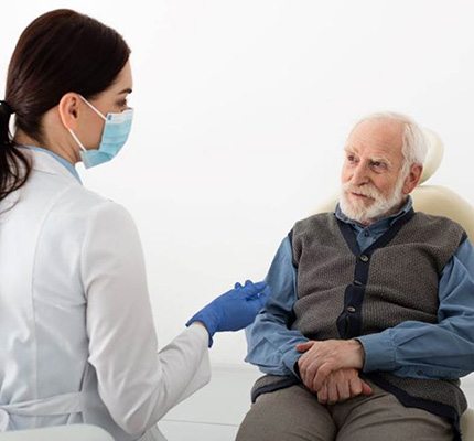 Senior patient listening to dental team member