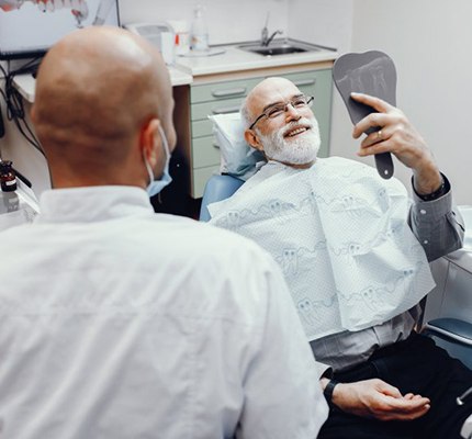 dentist discussing the cost of dentures with a patient 
