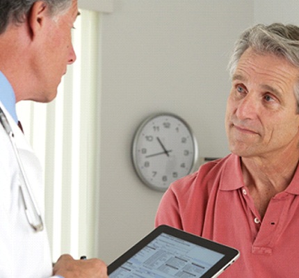 Dentist and patient discussing the cost of dental emergencies