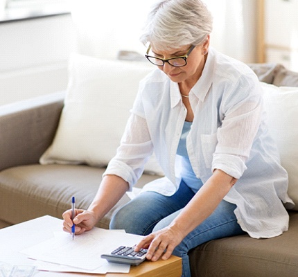 Woman looking over dental insurance coverage for dental emergencies