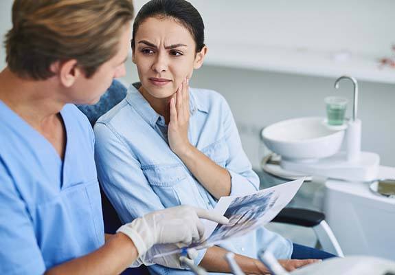 Patient learning about the cost of dental emergencies in Fanwood