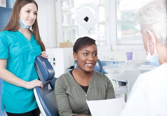 Healthy woman smiling at her emergency dentist 