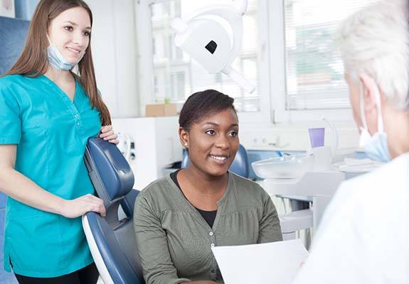 Healthy woman smiling at her Fanwood emergency dentist 