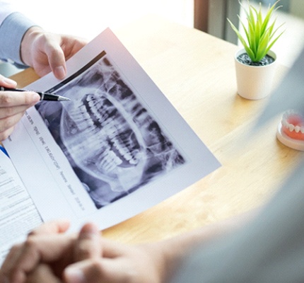Dentist discussing dental X-ray with patient