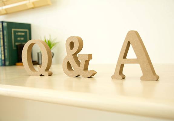 A wooden Q, & and A sitting on a shelf