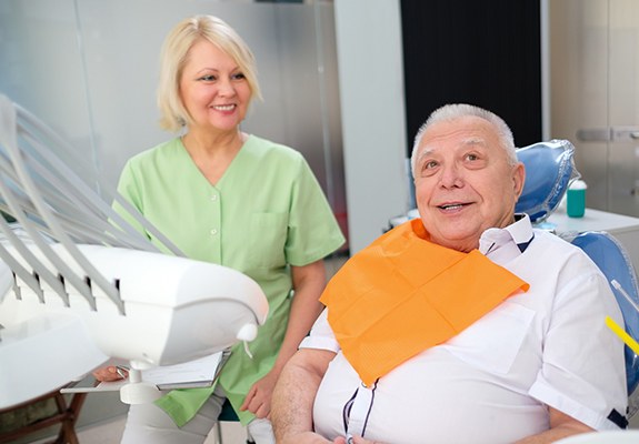A dental employee speaking to a patient