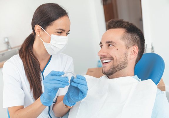 dentist discussing the cost of Invisalign with a patient 