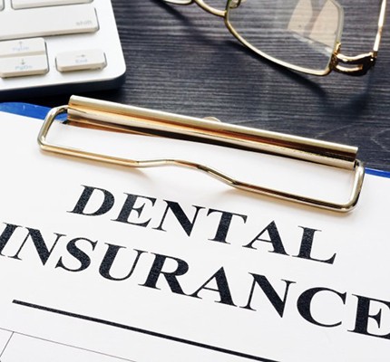 dental insurance form on a blue clipboard 