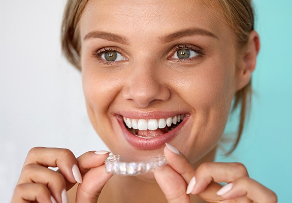 Woman placing Invisalign tray