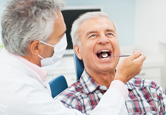 Older man receiving oral cancer screening