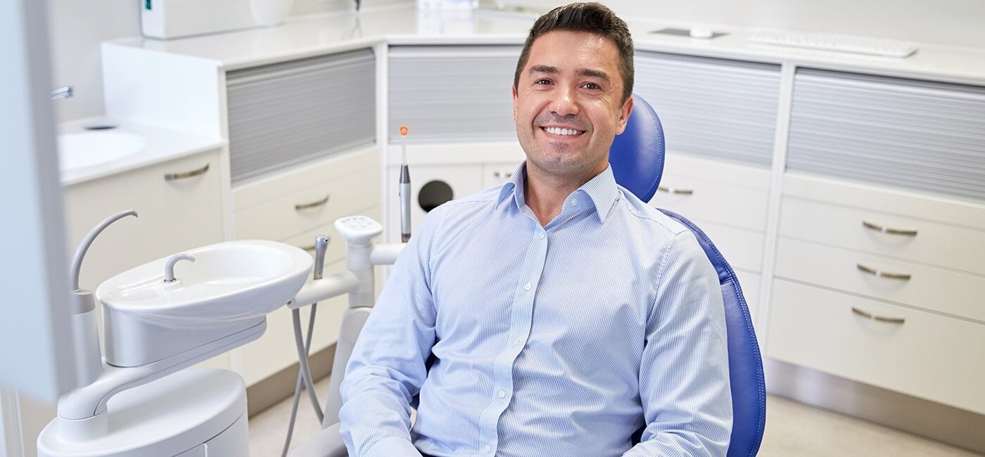 Man in dental chair smiling