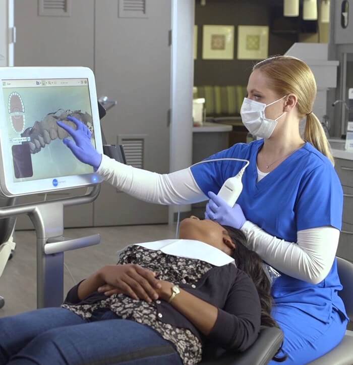 Dental team member capturing images of a patients smile