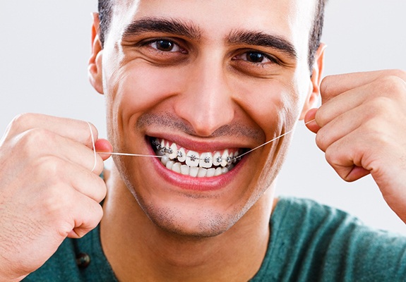 closeup of young woman smiling with braces