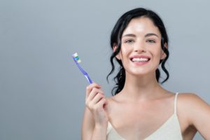 Smiling healthy woman with clean toothbrush thanks to Fanwood dentist