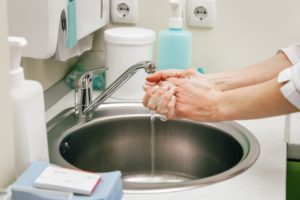dentist in Fanwood washing their hands before a treatment