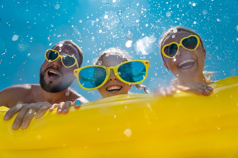 family smiling during summer vacation